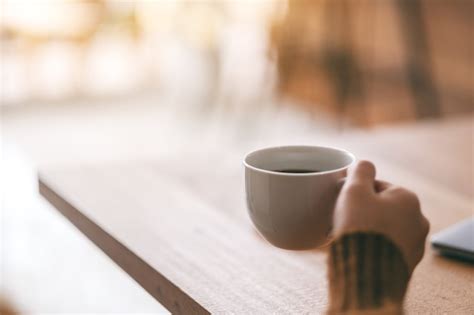 Premium Photo Closeup Image Of A Woman S Hand Holding A White Cup Of