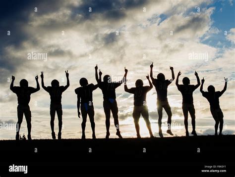 Silhouette of group of young american football players, celebrating ...