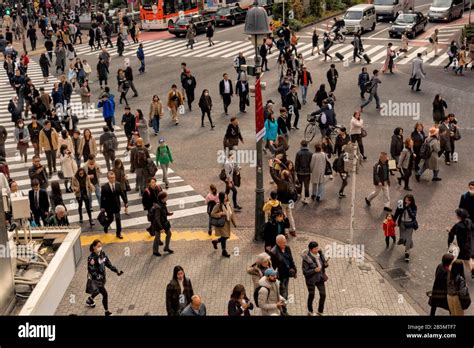 Horizontal Image Of People Crossing The Road On A Pedestrian Crossing