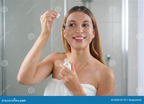 Portrait Of A Young Woman Applying Hyaluronic Acid At Home Skin Care