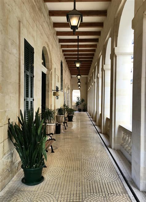 Narrow corridor in classic styled mansion decorated with various plants ...