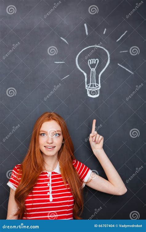 Attractive Inspired Woman Pointing Up And Having Idea Over Blackboard