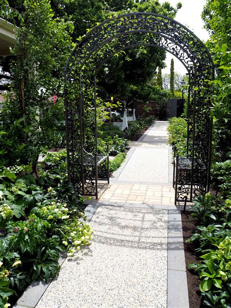 A Charming Metal Arc Covered By A Clematis Frame An Elegant Pathway