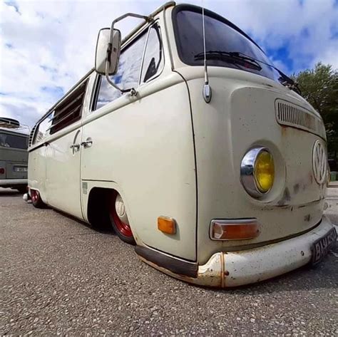 An Old Vw Bus Parked In A Parking Lot