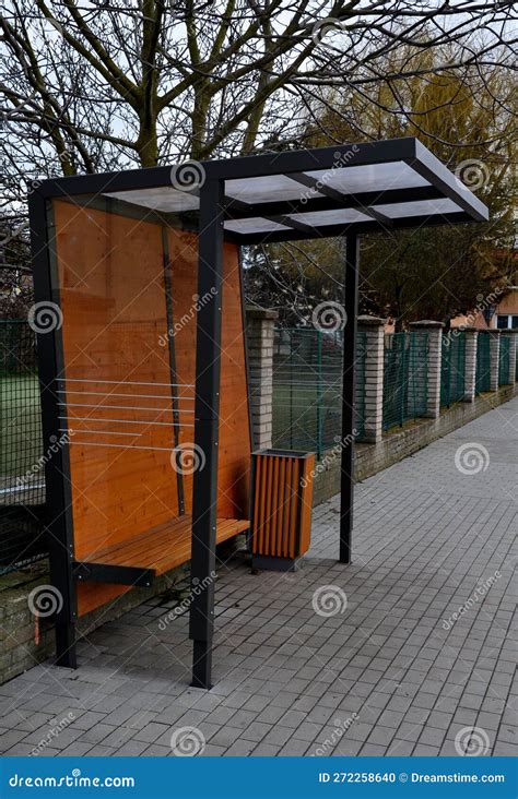 City Bus Stop Glass Shelter With Integrated Wooden Bench Stock Photo