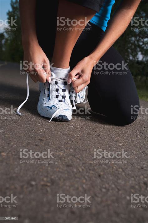 Female Runner Tying Her Shoelace Stock Photo Download Image Now 20