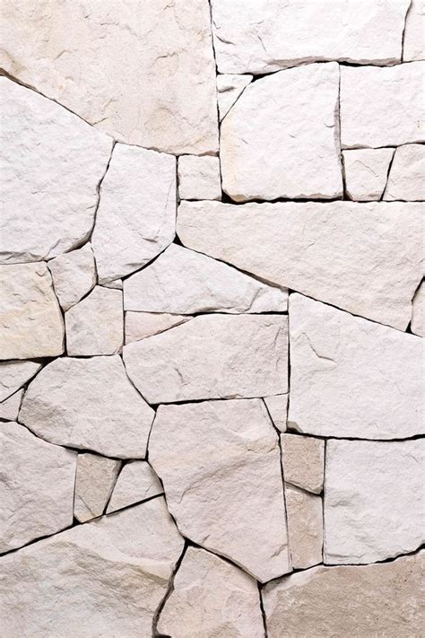 A White Stone Wall That Is Made Out Of Rocks