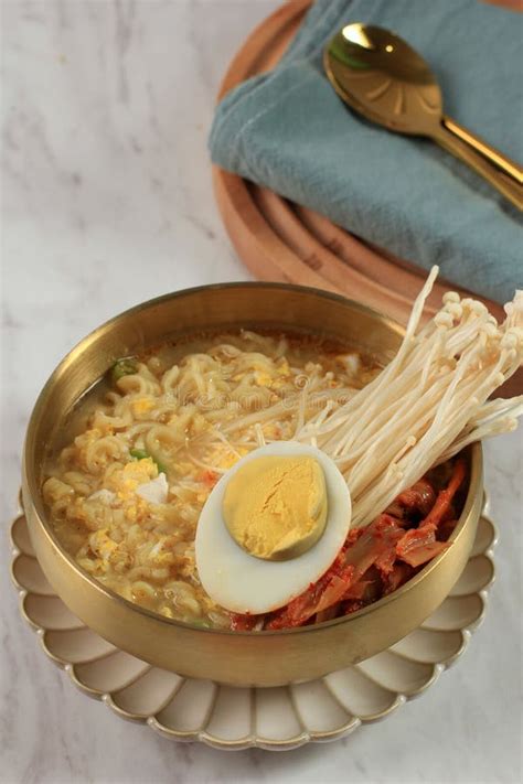 Korean Traditional Ramyeon Noodle With Egg Yolk Chilli Kimchi In A