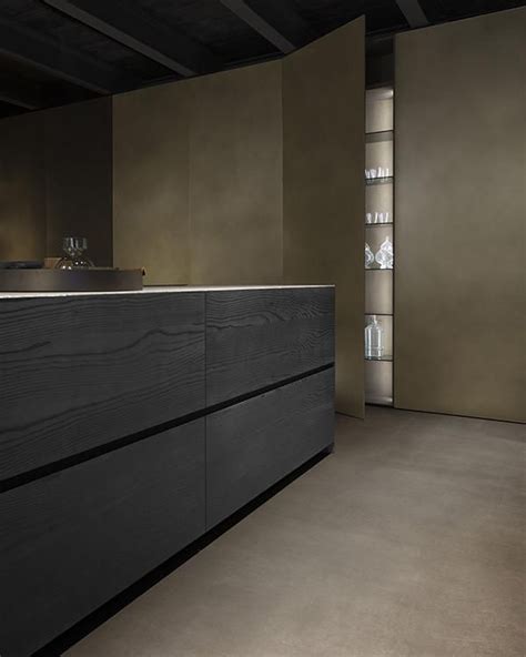 An Empty Kitchen With Black Cabinets And White Counter Tops Is Seen In