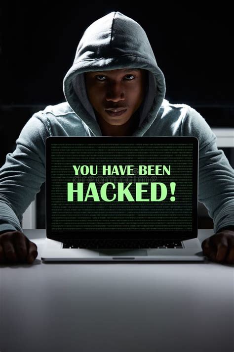 Beware The Dangers Of Cybercrime A Young Hacker Using A Laptop With