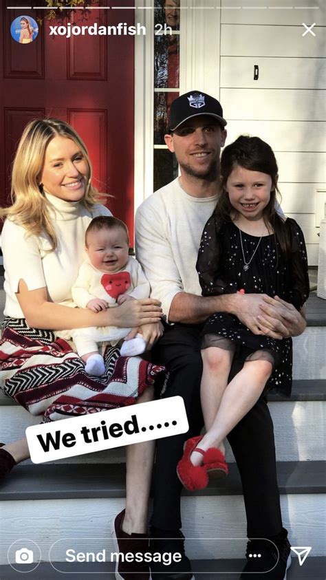 a man and woman sitting on the steps with their two children in front ...