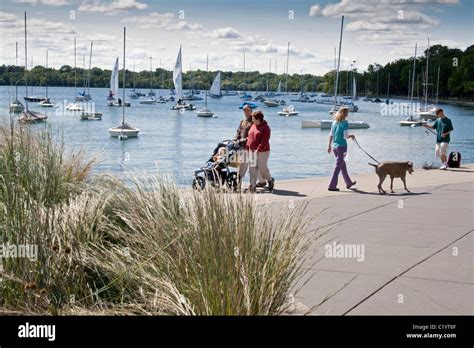 People walking along shoreline. Lake Harriet Park marina Minneapolis ...