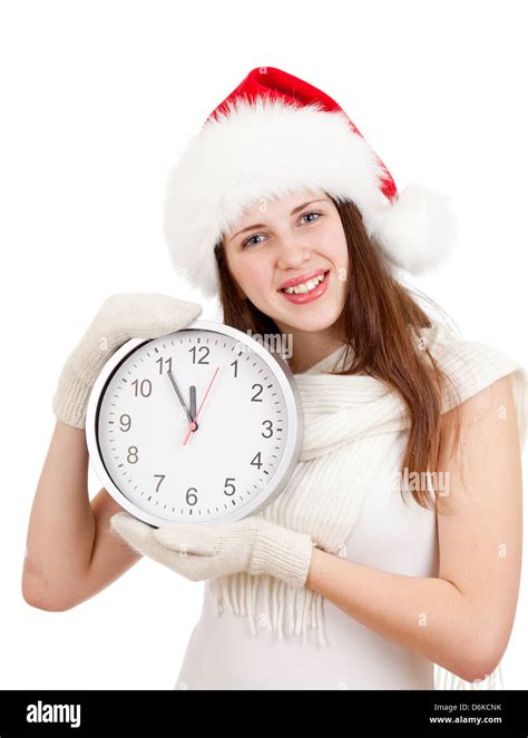 Cute Girl In Christmas Red Santa Hat With Clock Over A White Background