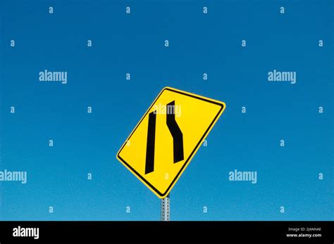 Freeway sign showing merge left as lane ends Stock Photo - Alamy