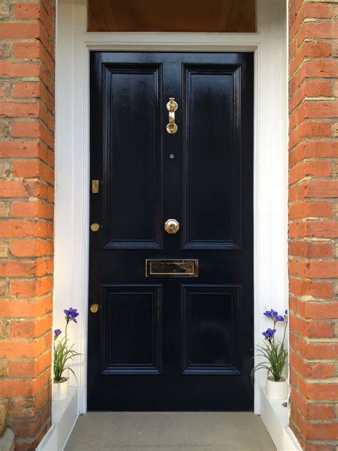 Swish Single 4 Panels Black Front Doors With Brass Handle Doors And Brick Porch Decor Wall