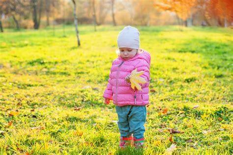 Happy Young Girl Smiling In Beautiful Autumn Park On Nature Walks