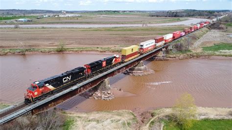 Awesome Aerial K View Long Stack Train Cn W Dpu Crossing Bridge