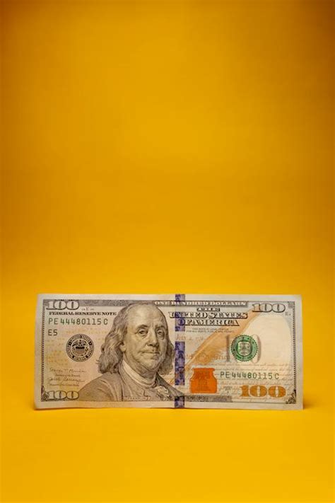 A Dollar Bill on Yellow Background · Free Stock Photo