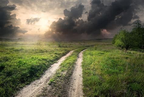 Premium Photo Lightning And Storm Clouds Over Country Road