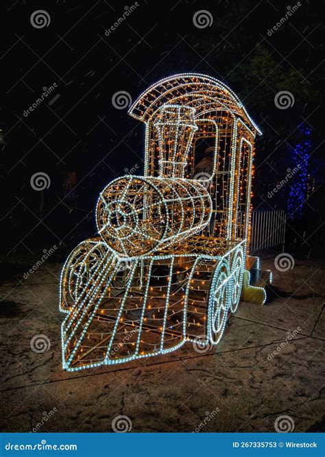 Closeup of a Decorated Train with Christmas Lights in a Dark Garden ...