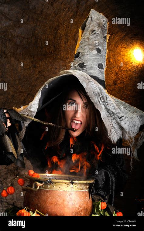 Halloween Witch Cooking In A Copper Cauldron Stock Photo Alamy