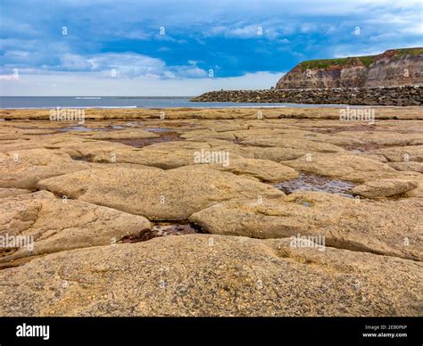 Rock pools on the beach at Staithes a village on the North Yorkshire ...