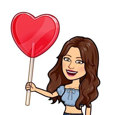 A Woman Holding A Heart Shaped Lollipop In One Hand And A Stick In The