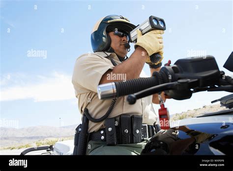 Police Officer Holding Radar Gun Stock Photo - Alamy