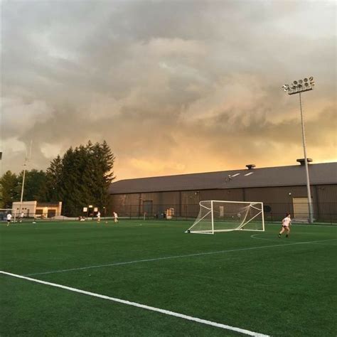 A Soccer Field With A Goalie Getting Ready To Kick The Ball