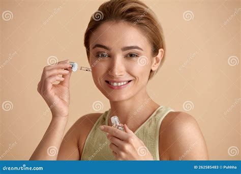 Woman Applying Serum On Face Woman Applying Essential Oil On Facial