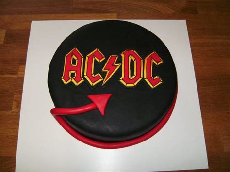 A Cake With The Word Ac Dc On It And An Arrow In The Middle