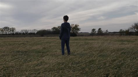 Sad Lonely Depressed Young Man Teenage Boy Standing Alone In A Field