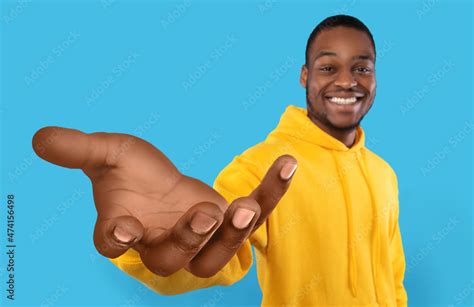 Happy Black Guy Showing Big Outstretched Hand Offering Help Taking Or