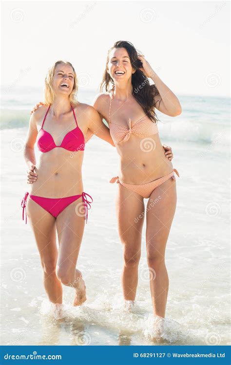 Two Happy Women In Bikini Walking On The Beach Stock Image Image Of