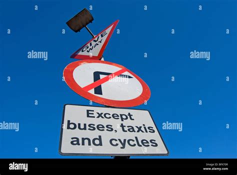 British Road Signs Indicating Give Way And No Right Turn Except For