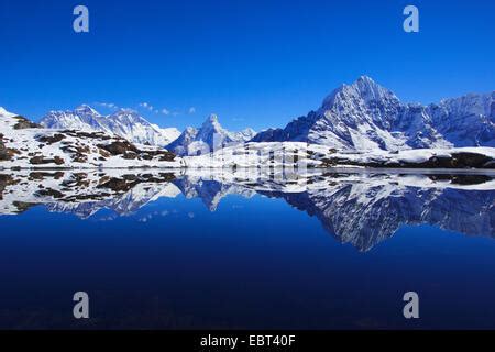 Nuptse Mount Everest And Ama Dablam Mirroring In Lake Kongde Nepal