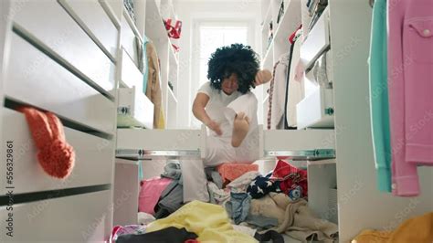 Upset Desperate Woman Of Color With Curly Black Hair Angrily Closing Drawers With Clothes