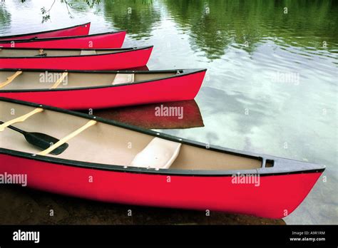 Red Boats On A Slow Flowing Reflective River Stock Photo Alamy