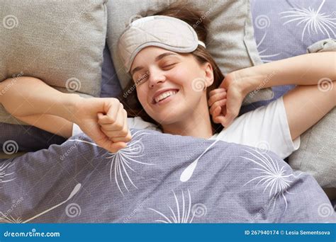 Portrait Of Happy Joyful Cheerful Woman Lying In Bed Stretching Her