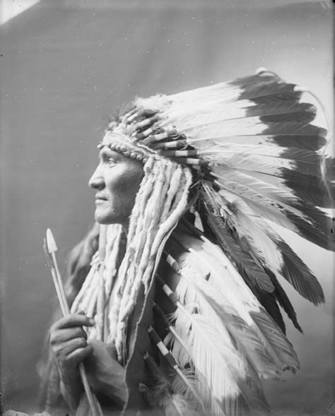 A Portrait Of An Unidentified Native American Man Wearing A Feather