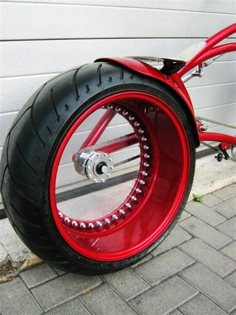 A Red And Black Motorcycle Parked Next To A Building