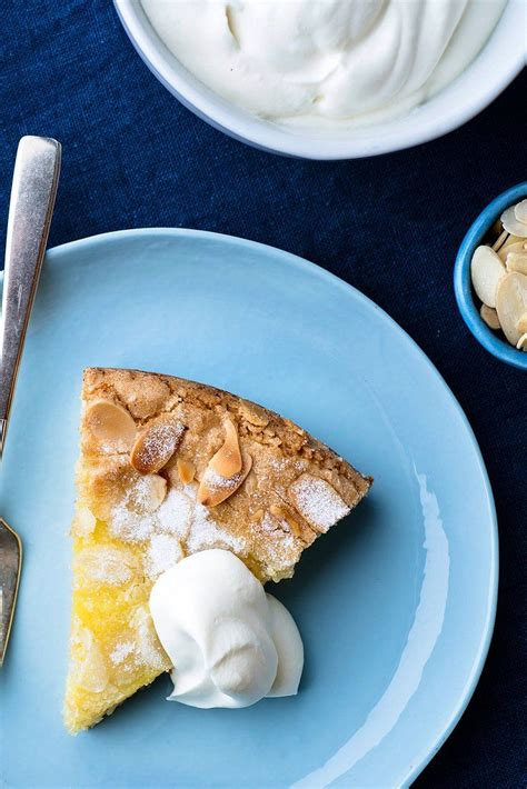 A Piece Of Pie On A Blue Plate Next To Some Whipped Cream And Other