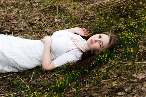 Beautiful Innocent Woman In White Dress Lying On The Grass Stock Image