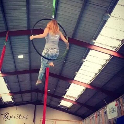 A Woman Is Doing Aerial Tricks On A Hoop