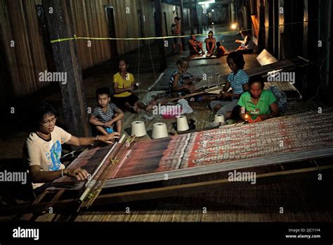 A Woman Weaving A Traditional Woven Fabric At The Longhouse Of