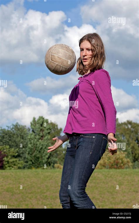 teenage girl practicing with a football Stock Photo - Alamy