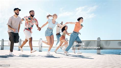 Full Length Shot Of A Diverse Group Of Friends Bonding And Holding