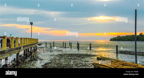 Jetty with sunset Stock Photo - Alamy