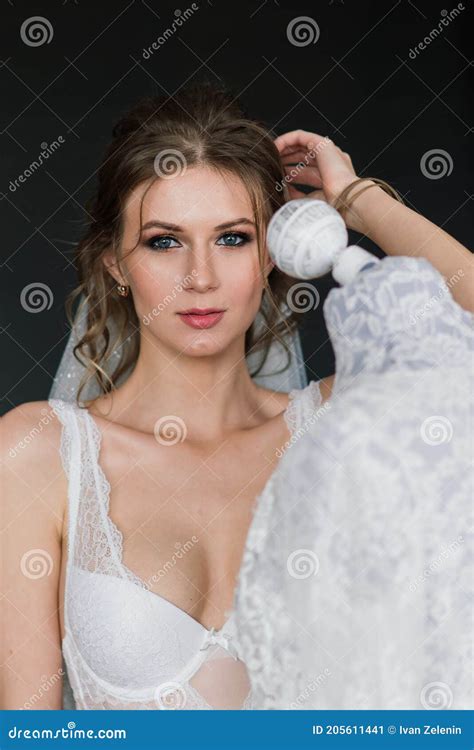 Beautiful Bride In White Lingerie Lying On The Bed In Her Bedroom Stock