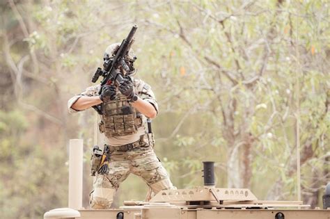 Premium Photo Soldiers In Camouflage Uniforms Hold Weapons Ready To